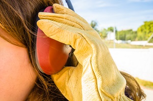 Image of woman wearing ear protection on the job.