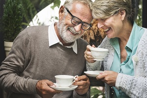 Image of older couple drinking tea and enjoying their hearing.