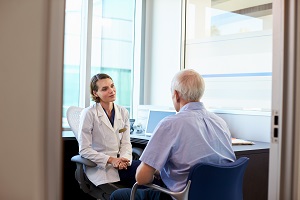 image of man talking to audiologist